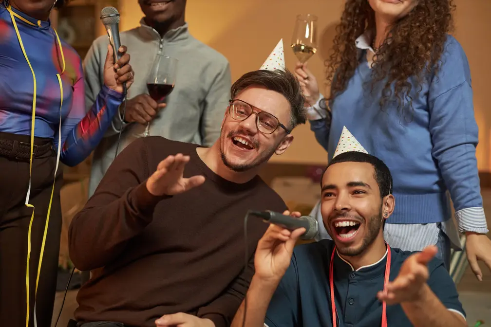 group of young adults socialising and singing karaoke